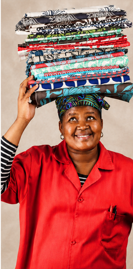 Mongoose artisan carrying colourful African textiles